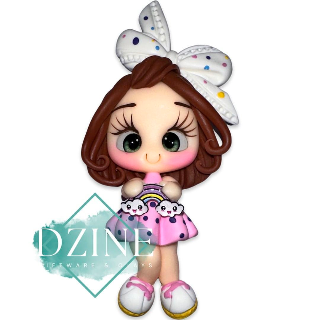 Girl holding rainbow in pink dress