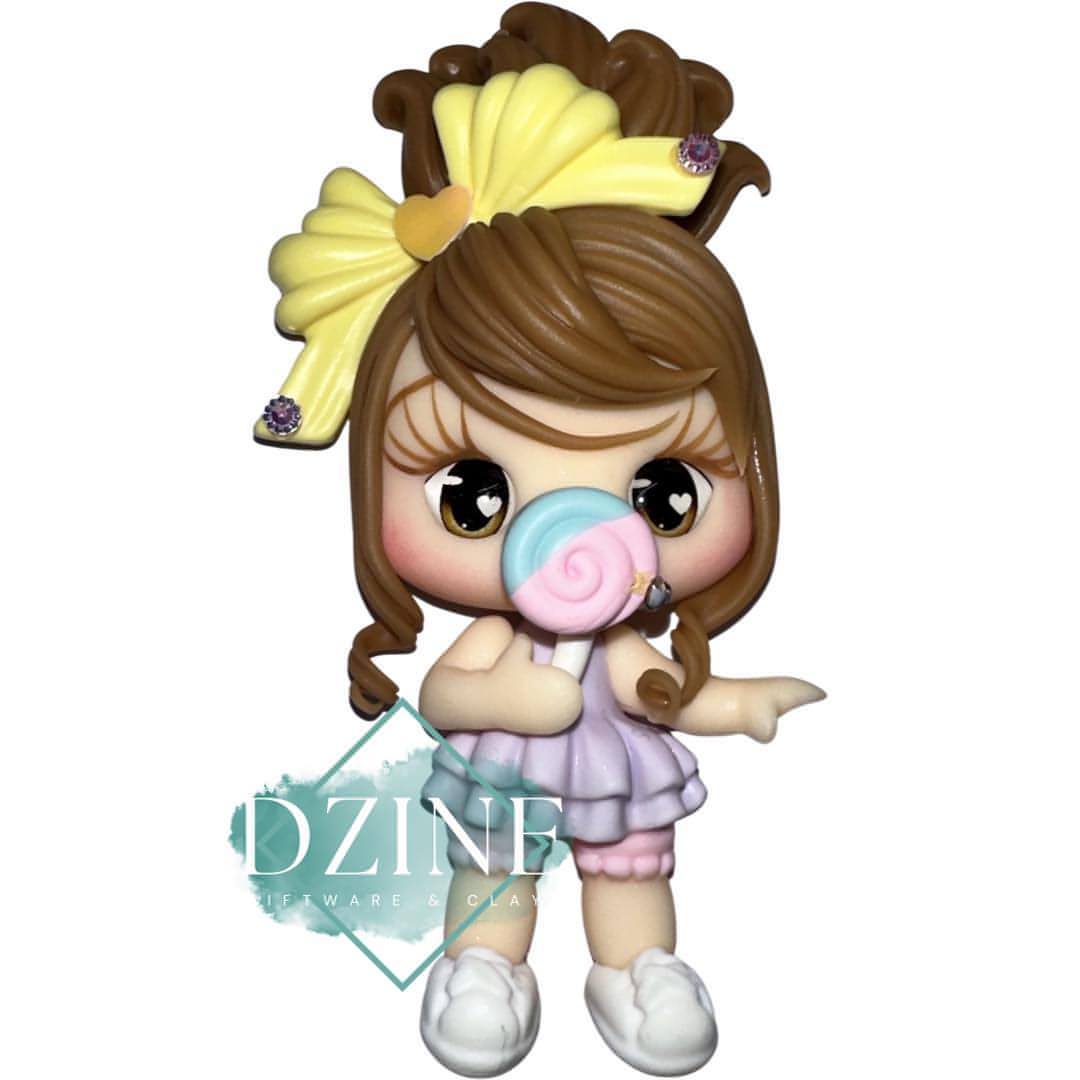 Cute girl with lollipop & yellow bow