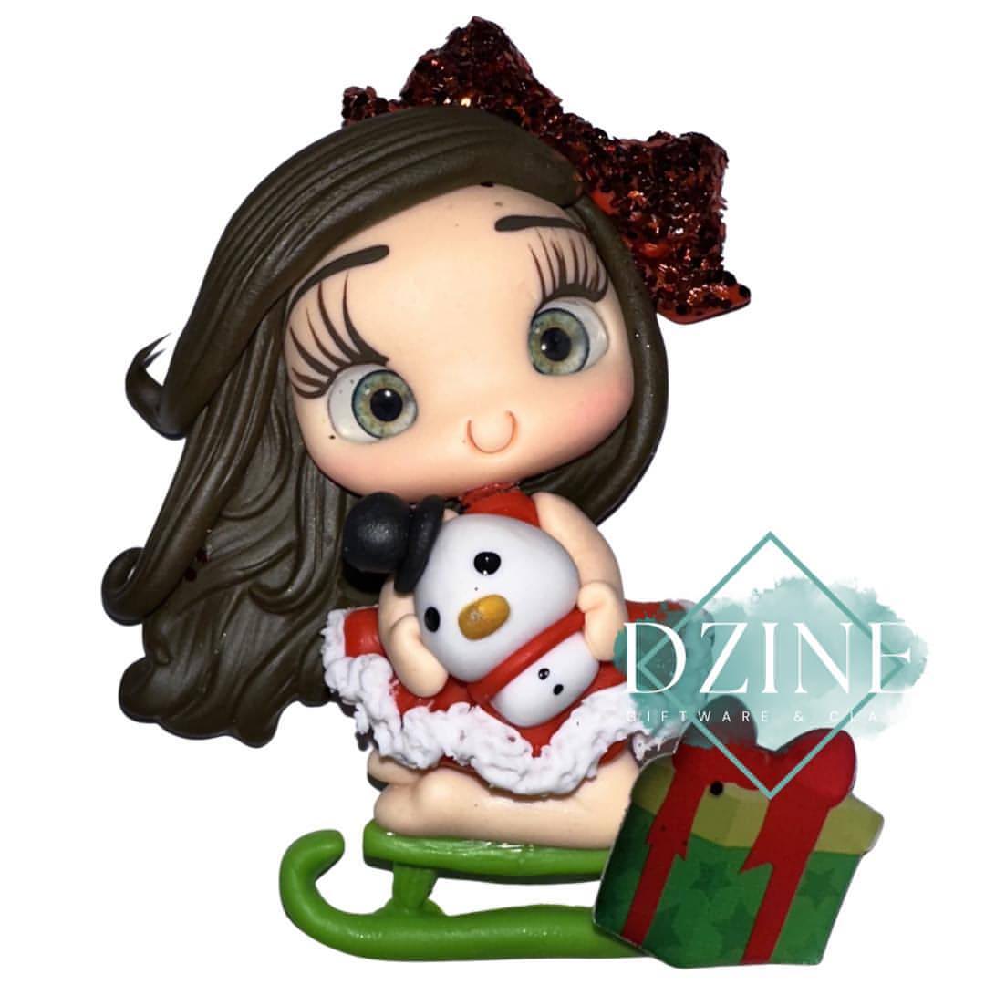 Christmas girl on sled with snowman