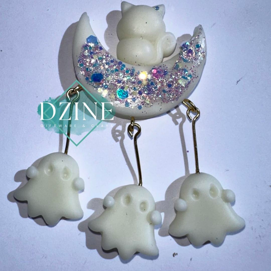 Glow in the dark cat on moon with skulls