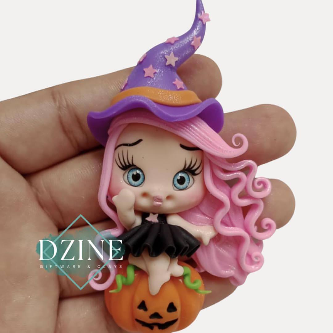 Cute witch on pumpkin